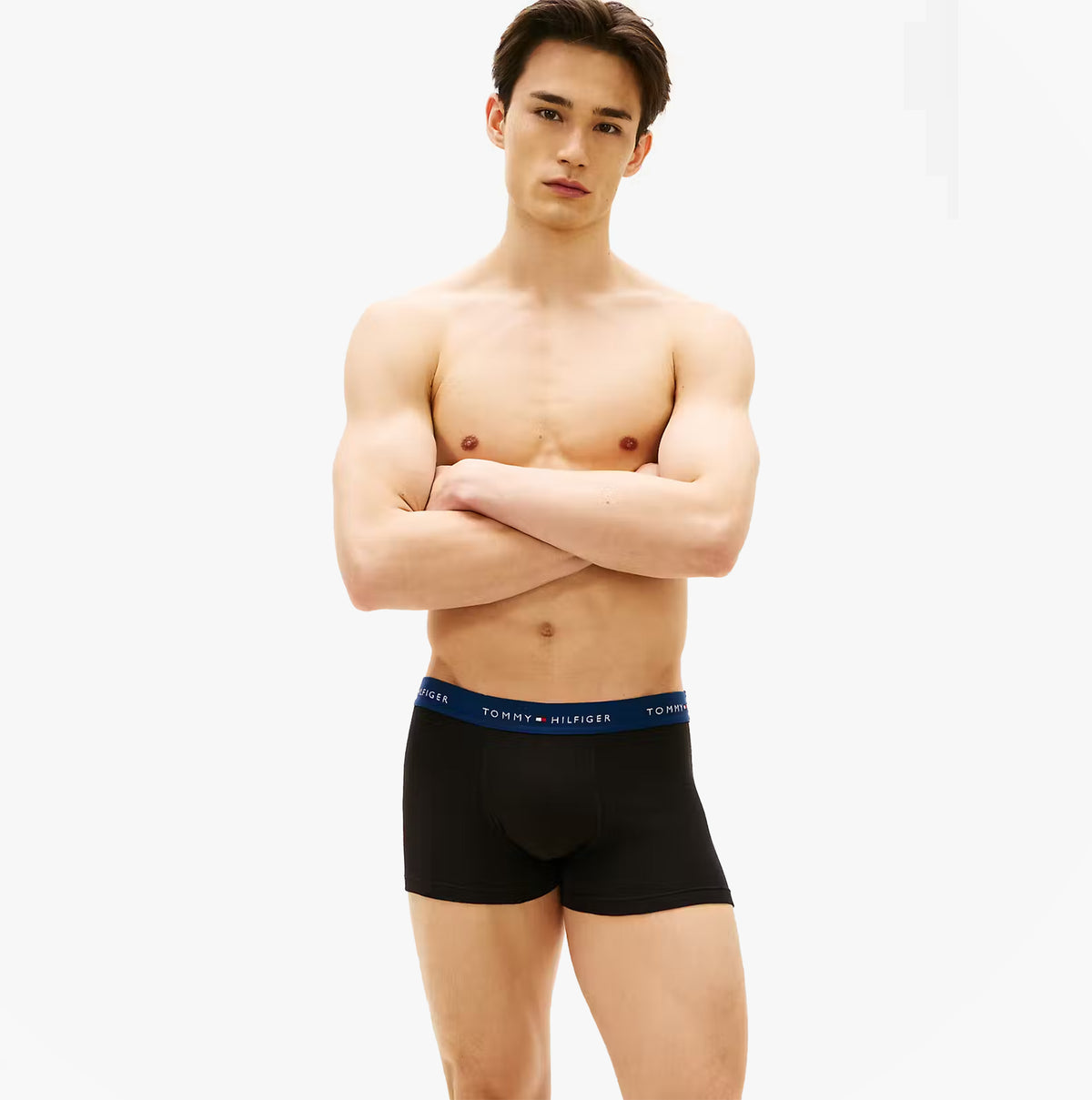 Tommy Hilfiger Mens 3 Pack Signature Repeat Logo Waistband Trunks black front view on model showcasing waistband design.
