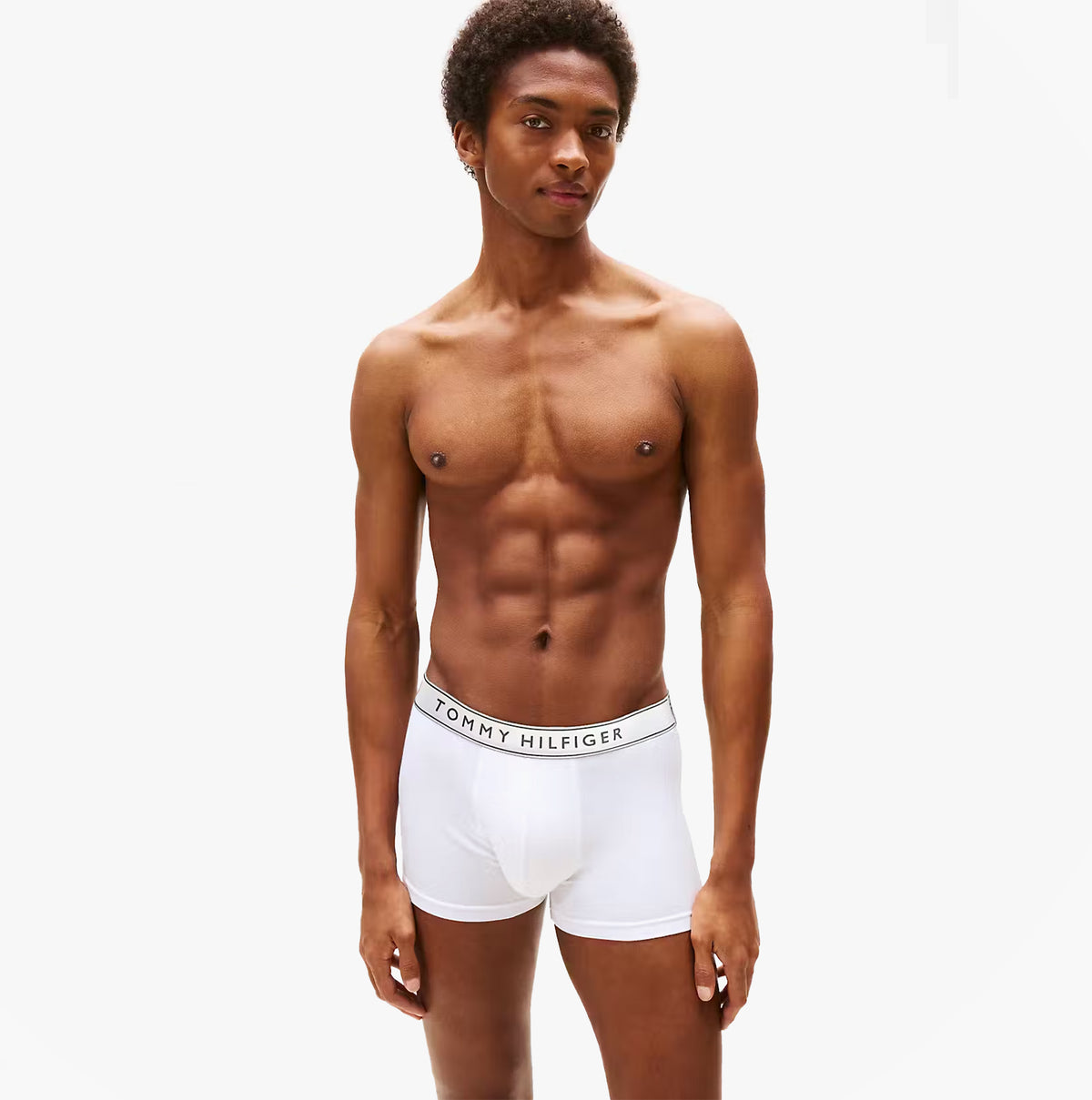 Tommy Hilfiger Mens 3 Pack Trunks Grey/Black/White front view on model wearing white trunks with logo waistband.