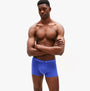Tommy Hilfiger 3 PACK Mens Trunks Multicoloured side view on male model wearing blue trunks with logo waistband.