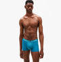 Tommy Hilfiger 3 PACK Mens Trunks Multicoloured front view on model wearing teal trunks with logo waistband.