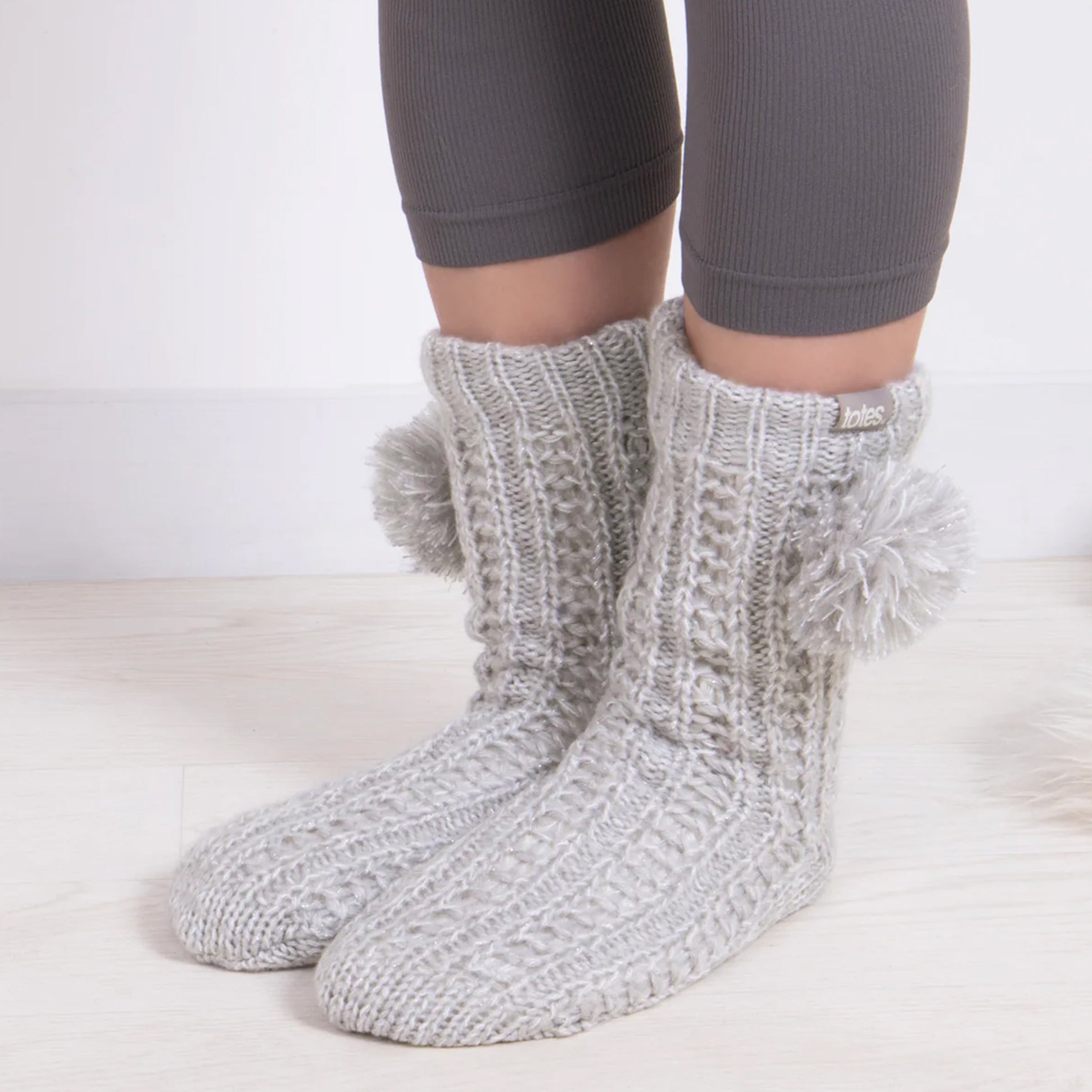 Totes Toasties LUXURY SPARKLE Pom Slipper-Sox Womens Grey side view showing knitted texture and pom poms.
